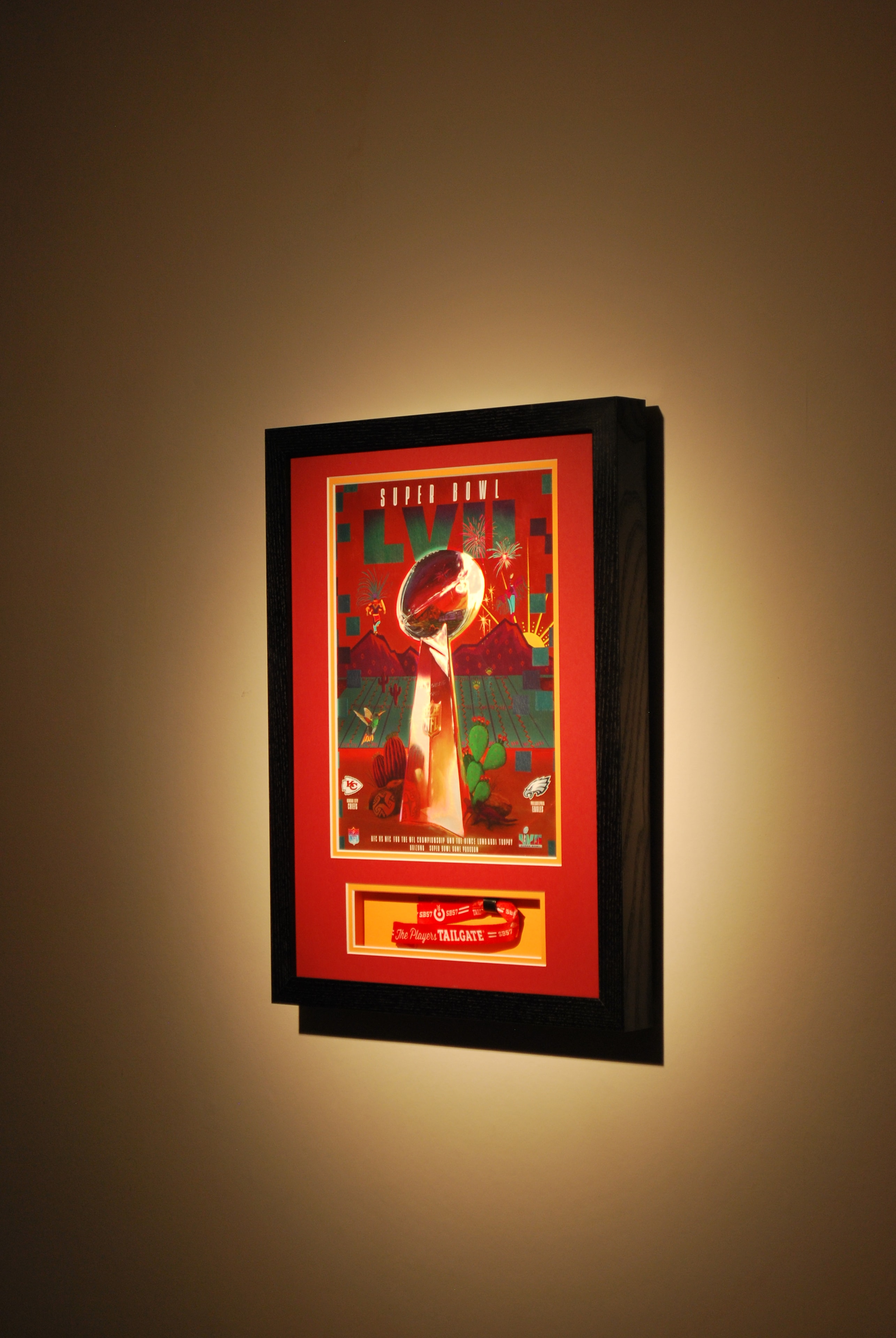 Super Bowl programme and wristband, double mounted in black frame